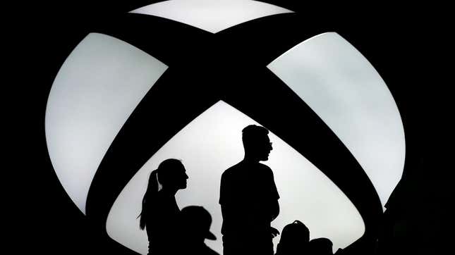 Workers stand in from of an Xbox logo waiting to see if Microsoft stands by its pro-union talk. 