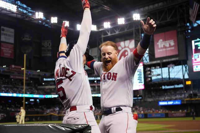 May 26, 2023; Phoenix, Arizona, USA; Boston Red Sox shortstop Enrique Hernandez (5) celebrates with Boston Red Sox third baseman Justin Turner (2) after hitting a two run home run against the Arizona Diamondbacks during the third inning at Chase Field.