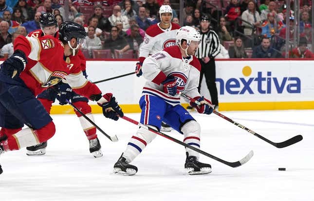 Mar 16, 2023; Sunrise, Florida, USA; Montreal Canadiens center Chris Tierney (67) keeps the puck away from Florida Panthers defenseman Aaron Ekblad (5) in the first period at FLA Live Arena.