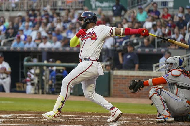 Aug 23, 2023; Cumberland, Georgia, USA; Atlanta Braves designated hitter Marcell Ozuna (20) drives in a run with a single against the New York Mets during the first inning at Truist Park.