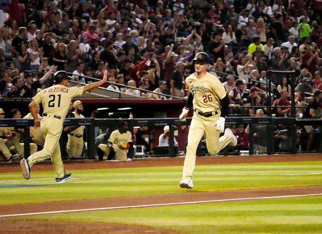 Jun 16, 2023; Phoenix, AZ, USA; Arizona Diamondbacks designated hitter Pavin Smith (26) scores on a Corbin Carroll RBI-double against the Cleveland Guardians in the sixth inning at Chase Field.