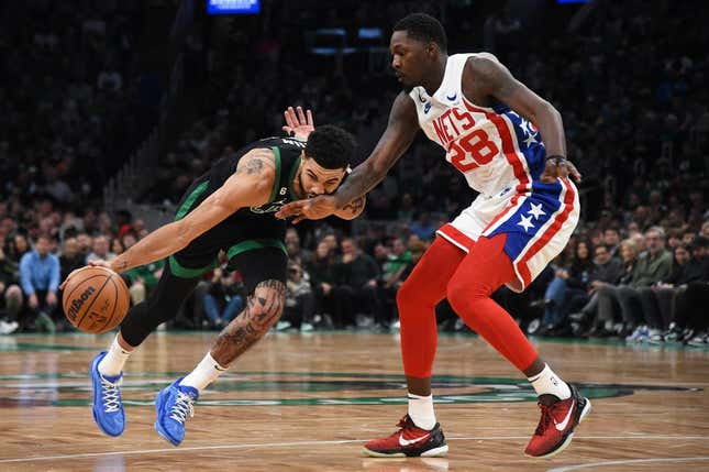 Mar 3, 2023; Boston, Massachusetts, USA;  Brooklyn Nets forward Dorian Finney-Smith (28) defends Boston Celtics forward Jayson Tatum (0) during the first half at TD Garden.