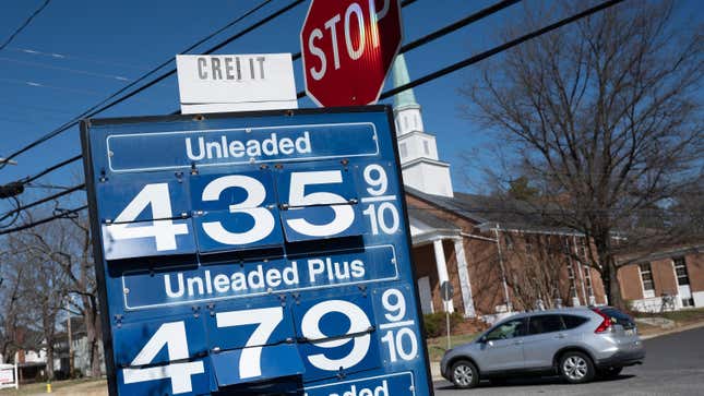 A car passes a gas station sign in Annapolis, Maryland, on March 14, 2022, as record high gas prices hit working class Americans with inflation already surging. 