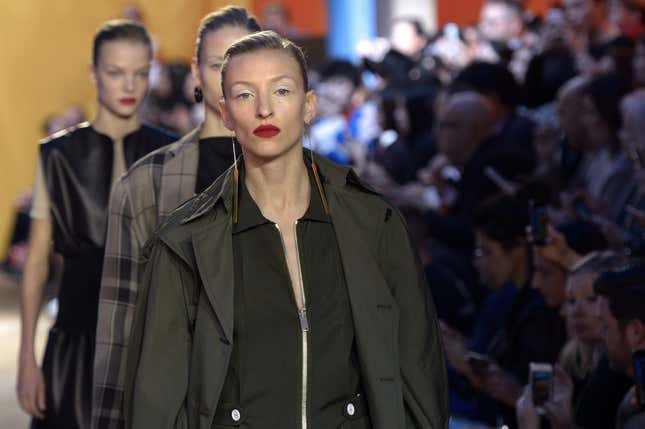 Models present creations for Celine during the 2016 Spring/Summer ready-to-wear collection fashion show, on October 4, 2015 in Paris.