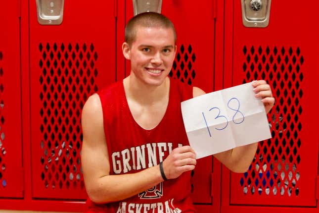 Grinnell’s Jack Taylor holding up the number of points he scored in a single game.