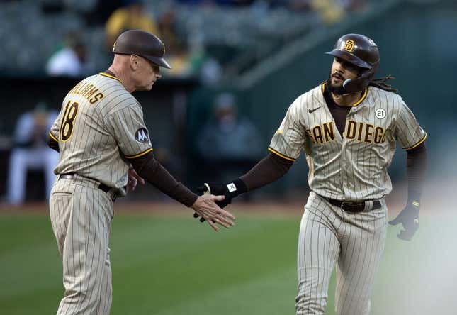 Sep 15, 2023; Oakland, California, USA; San Diego Padres right fielder Fernando Tatis Jr. (right) gets a congratulatory handshake from third base coach Matt Williams (18) after hitting a solo home run against the Oakland Athletics during the first inning at Oakland-Alameda County Coliseum.