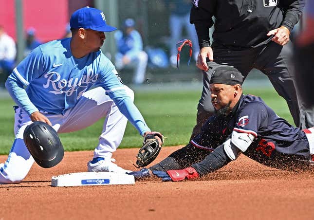 Apr 1, 2023; Kansas City, Missouri, USA;  Minnesota Twins designated hitter Byron Buxton (25) dives into second base with a double during the first inning against Kansas City Royals second baseman Nicky Lopez (8) at Kauffman Stadium.