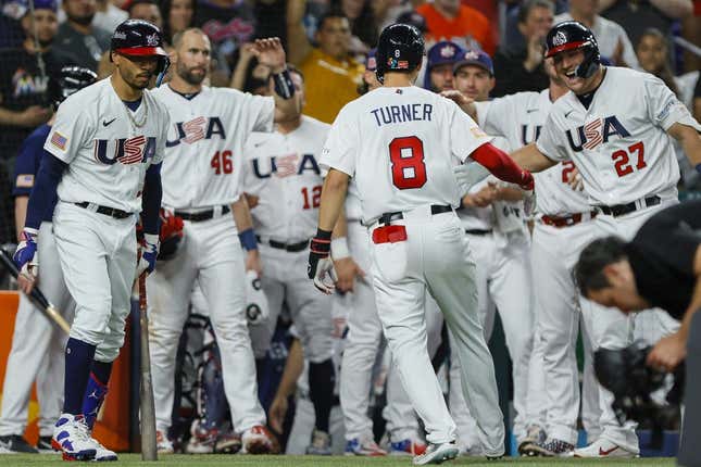 Mar 19, 2023; Miami, Florida, USA; USA shortstop Trea Turner (8) celebrates with teammates after hitting a home run during the second inning against Cuba at LoanDepot Park.