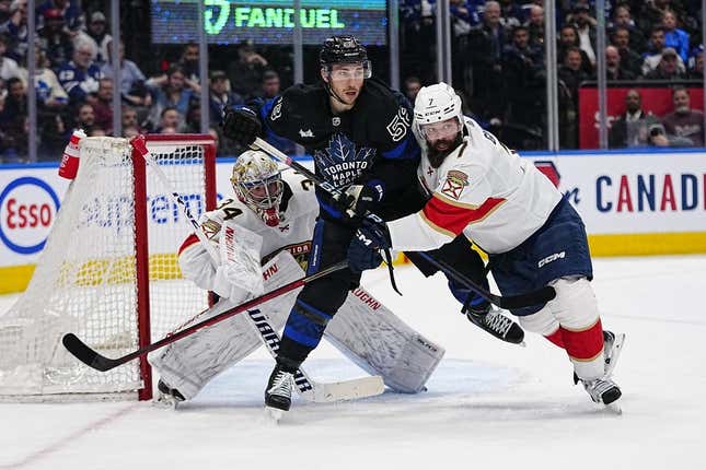 Mar 29, 2023; Toronto, Ontario, CAN; Florida Panthers goaltender Alex Lyon (34) looks for the puck as  defenseman Radko Gudas (7) tries to clear Toronto Maple Leafs forward Michael Bunting (58) away from the front of the net during the first period at Scotiabank Arena.