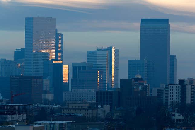 FILE - Pollution obscures the skyline of downtown as the sun rises over Denver, on Feb. 28, 2019. The Environmental Protection Agency is delaying plans to tighten air quality standards for ground-level ozone — better known as smog — despite a recommendation by a scientific advisory panel to lower air pollution limits to protect public health. (AP Photo/David Zalubowski, File)