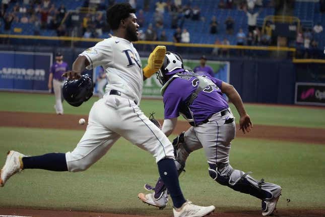 Aug 23, 2023; St. Petersburg, Florida, USA; Tampa Bay Rays shortstop Osleivis Basabe (37) scores the winning run off a hit by second baseman Brandon Lowe (8) as Colorado Rockies catcher Elias Diaz (35) tries to make the tag during the tenth inning at Tropicana Field.