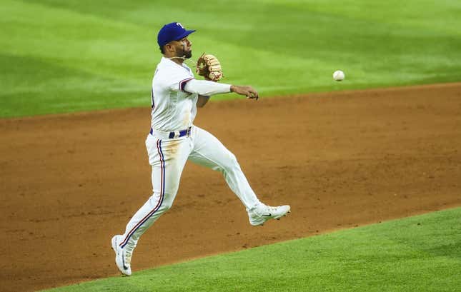 May 2, 2023; Arlington, Texas, USA; Texas Rangers shortstop Ezequiel Duran (20) fields a ground ball and throws to first base during the sixth inning against the Arizona Diamondbacks at Globe Life Field.