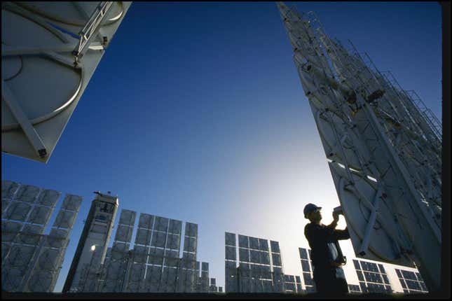 A Technician Servicing Photovoltaic Cells In Solar Energy Farm In Albuquerque, New Mexico.