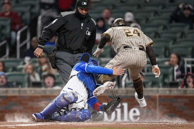 Apr 8, 2023; Cumberland, Georgia, USA; San Diego Padres right fielder Rougned Odor (24) is tagged out on a collision with Atlanta Braves catcher Travis d&#39;Arnaud (16) during the fourth inning  at Truist Park.