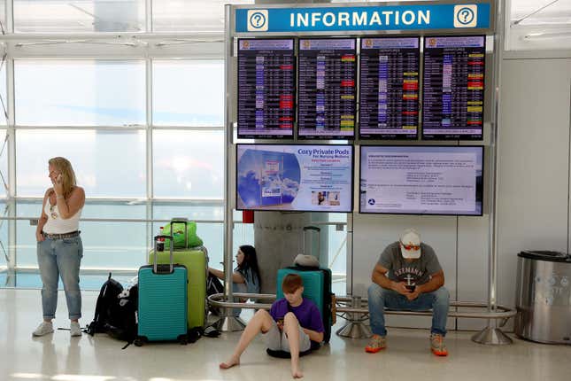 Travelers wait to hear when they can continue to Germany after the Fort Lauderdale-Hollywood International Airport was closed due to the flooded runways on April 13, 2023 in Fort Lauderdale, Florida.