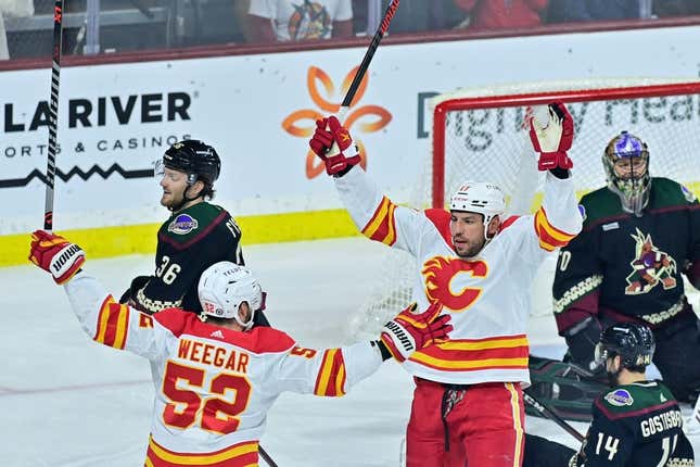 Feb 22, 2023; Tempe, Arizona, USA; Calgary Flames left wing Milan Lucic (17) celebrates with defenseman MacKenzie Weegar (52) after scoring a goal in the first period against the Arizona Coyotes at Mullett Arena.