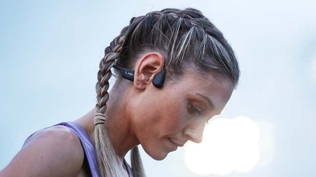 An athlete with their head bowed wearing Shokz's OpenRun Pro Premium Bone Conduction Sport Headphones.