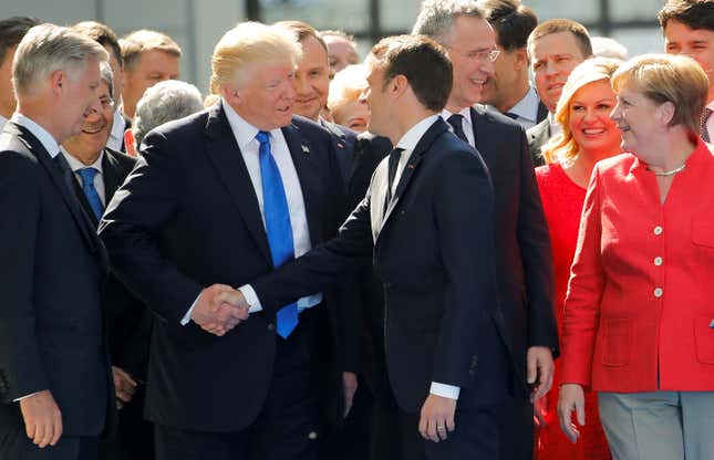 Trump shakes hands with French president Emmanuel Macron in front of NATO leaders in May 2017.