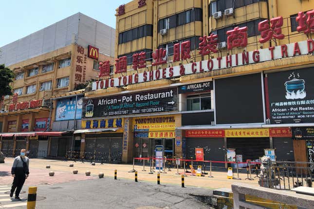 An African restaurant is closed off along with other businesses in Guangzhou where a neighborhood is in lockdown after several people tested positive for the novel coronavirus disease April 13, 2020.