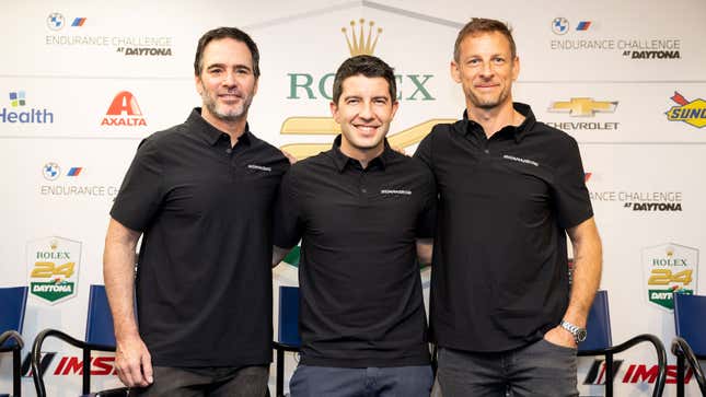 A photo of Jimmie Johnson, Mike Rockenfeller, and Jenson Button at an event in Florida. 