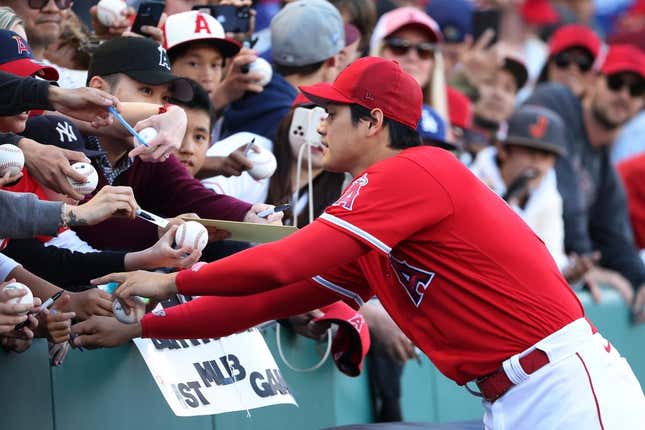 Mar 27, 2023; Anaheim, California, USA;  Los Angeles Angels designated hitter Shohei Ohtani (17) signs autographs for fans before a game against the Los Angeles Dodgers at Angel Stadium.