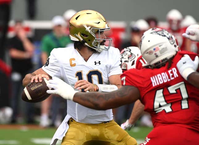 Sep 9, 2023; Raleigh, North Carolina, USA; Notre Dame Fighting Irish quarterback Sam Hartman (10) looks to pass as he is pressured by North Carolina State Wolfpack defensive lineman Jykeveous Red Hibbler(47) during the first half  at Carter-Finley Stadium.