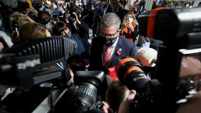 The President of the UN Climate Change Conference (COP26), Alok Sharma, talks to the media as he walks at the COP26 conference center, in Glasgow.
