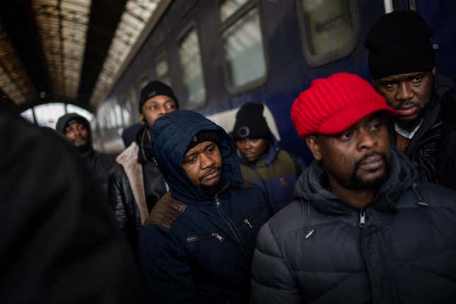 African residents in Ukraine wait at the platform inside Lviv railway station, Sunday, Feb. 27, 2022, in Lviv, west Ukraine. As hundreds of thousands of Ukrainians seek refuge in neighboring countries, cradling children in one arm and clutching belongings in the other, leaders in Poland, Hungary, Bulgaria, Moldova and Romania are offering a hearty welcome.