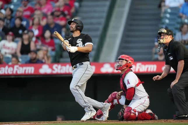 June 28, 2023; Anaheim, California, USA; Chicago White Sox catcher Seby Zavala (44) continues his home run in the second inning as Los Angeles Angels catcher Chad Wallach (35) and home plate umpire Chad Whiston watch at Angel Stadium.