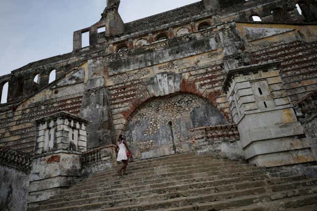 A woman climbs the stairs on the remains of Sans-Souci Palace in Milot, Haiti