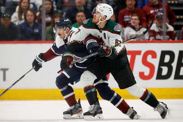 Mar 11, 2023; Denver, Colorado, USA; Arizona Coyotes left wing Lawson Crouse (67) and Colorado Avalanche left wing Matt Nieto (83) battle for position in the second period at Ball Arena.