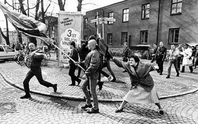 A woman hitting a neo-Nazi with her handbag.