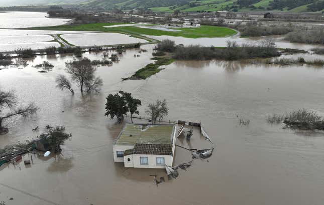 In an aerial view, a home is seen submerged in floodwater as the Salinas River begins to overflow its banks on January 13, 2023 in Salinas, California.