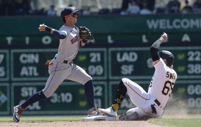 Apr 12, 2023; Pittsburgh, Pennsylvania, USA;  Houston Astros second baseman Mauricio Dubon (14) turns a double play over Pittsburgh Pirates center fielder Jack Suwinski (65) during the fifth inning at PNC Park.