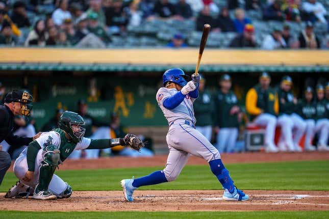 Apr 14, 2023; Oakland, California, USA;  New York Mets shortstop Francisco Lindor (12) hits a grand slam home run against the Oakland Athletics during the second inning at RingCentral Coliseum.