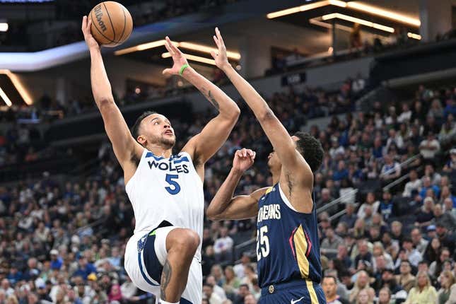 Apr 9, 2023; Minneapolis, Minnesota, USA; Minnesota Timberwolves forward Kyle Anderson (5) goes to the basket as New Orleans Pelicans guard Trey Murphy III (25) defends during the second quarter at Target Center.