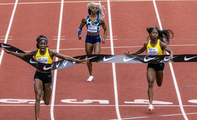 Jamaica’s Elaine Thompson-Herah, left, wins the 100 meters, as American track and field sprinter Sha’carri Richardson, center, also competes, Saturday, Aug. 21, 2021, at the Prefontaine Classic track and field meet in Eugene, Ore. Richardson finished in last place.