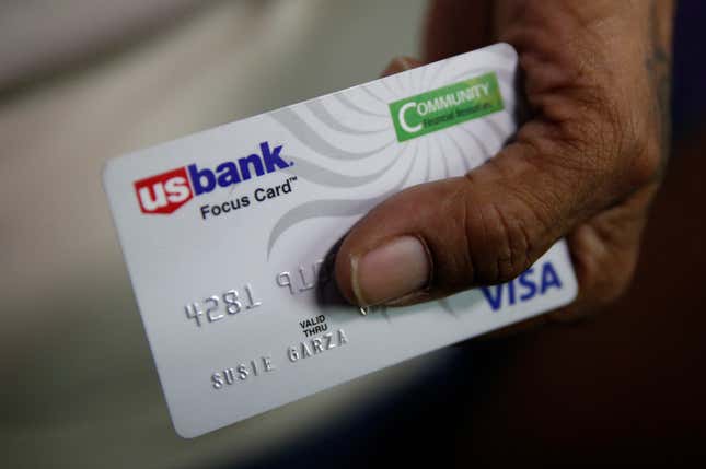 In this Aug. 14, 2019, file photo, Susie Garza displays the city provided debit card she receives monthly through a trial program in Stockton, Calif. A study of people in California who received $500 a month for free says they used it to pay off debt and get full-time jobs. New data from a similar pilot that gave monthly checks to single mothers found that brain activity spiked in their children, which could lead to better development outcomes.