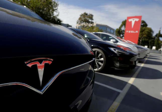 Teslas parked on a Tesla lot.