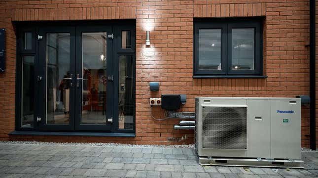 Ground source heat pump sits outside a home.