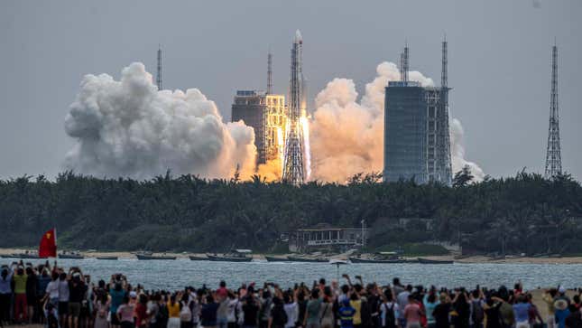 People watch a Long March 5B rocket, carrying China’s Tianhe space station core module, as it lifts off from the Wenchang Space Launch Center in southern China’s Hainan province on April 29, 2021