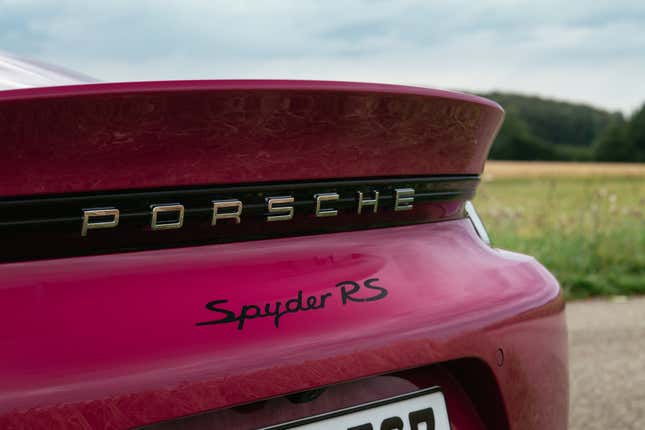 The rear spoiler of a 2023 Porsche 718 Spyder RS in Rubystone Neo