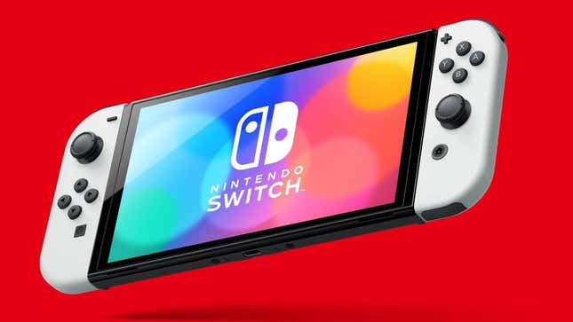 A Nintendo Switch OLED model hangs in front of a red background. 
