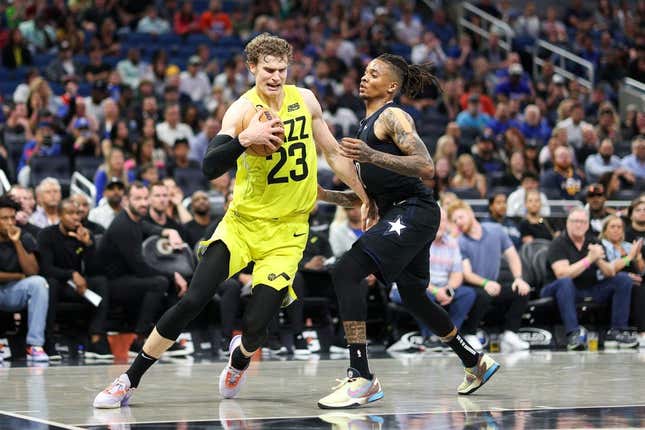 Mar 9, 2023; Orlando, Florida, USA; Utah Jazz forward Lauri Markkanen (23) drives to the hope past Orlando Magic guard Markelle Fultz (20) in the fourth quarter at Amway Center.