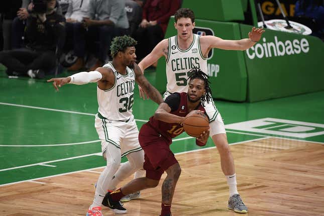 Mar 1, 2023; Boston, Massachusetts, USA;  Cleveland Cavaliers guard Darius Garland (10) controls the ball while Boston Celtics guard Marcus Smart (36) and forward Mike Mascala (57) defend during the first half at TD Garden.