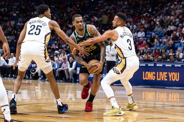Mar 23, 2023; New Orleans, Louisiana, USA;  Charlotte Hornets forward P.J. Washington (25) is fouled by New Orleans Pelicans guard Trey Murphy III (25) and guard CJ McCollum (3) during the first half at Smoothie King Center.