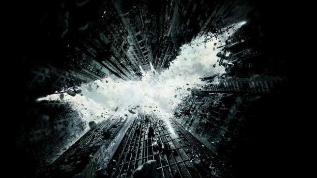 The teaser poster for The Dark Knight Rises, with the Batman symbol as formed by destroyed buildings. 
