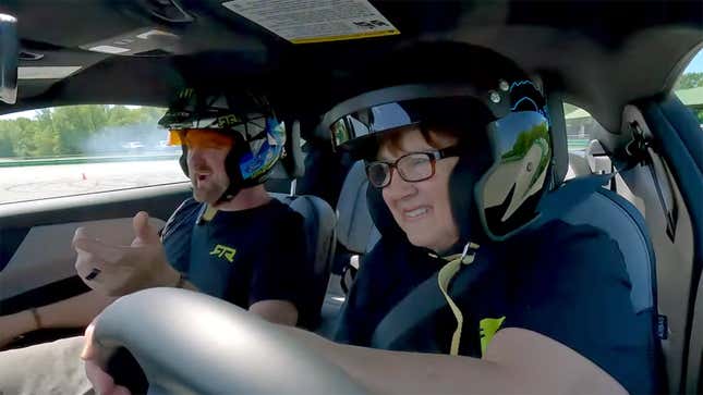 Dawn Gittin, mother of Formula Drift champion Vaughn Gittin Jr., drifts a 2024 Ford Mustang as her son coaches her from the passenger seat.