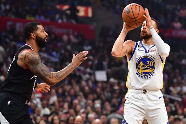 Mar 15, 2023; Los Angeles, California, USA; Golden State Warriors guard Stephen Curry (30) shoots against Los Angeles Clippers forward Marcus Morris Sr. (8) during the first half at Crypto.com Arena.