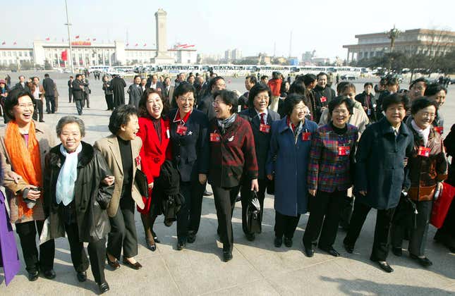 Women delegates to the Chinese People’s Political Consultative Conference walk from Tiananmen Square to a plenary meeting.